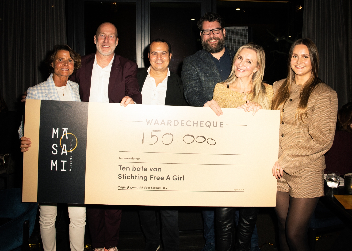 Team Masami and Free a Girl holding the €150.000 cheque